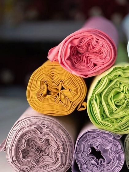 Rolls of colorful fabric, each waiting to be transformed. This is where the story of your blouse begins, with a choice of color and texture.