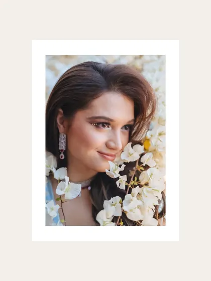 A beautiful, soft-focus portrait of the bride surrounded by white orchids.