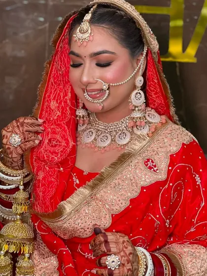 A candid shot of the bride adjusting her dupatta, giving a lovely view of her profile, hairstyle, and the intricate kalire.