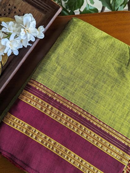 A lovely combination of mehendi green and maroon in this Ilkal saree. The golden detailing on the border adds a festive touch.
