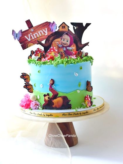 A bright, clear shot of the Masha and the Bear themed cake.