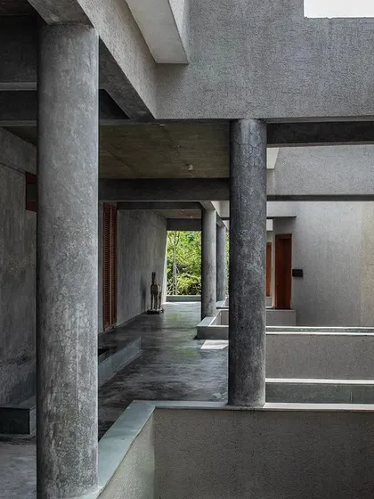 The strong, rhythmic columns of the Anahaspa retreat create a powerful architectural statement, defining corridors that are open to the elements.