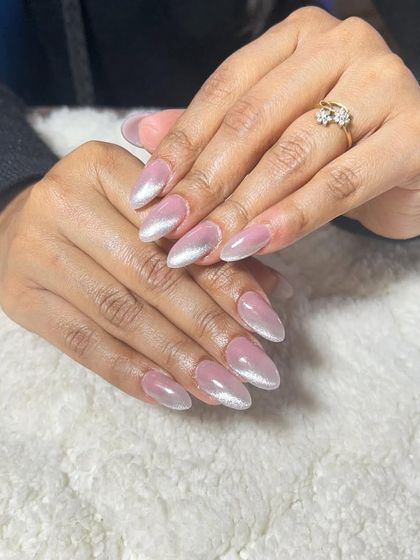 A pearly cat-eye effect on almond nails. This creates a soft, shimmery look that is very elegant.