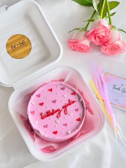 A fun and girly birthday cake for the "birthday girlie". The pink buttercream is decorated with a mix of red, pink, and white hearts for a festive look.