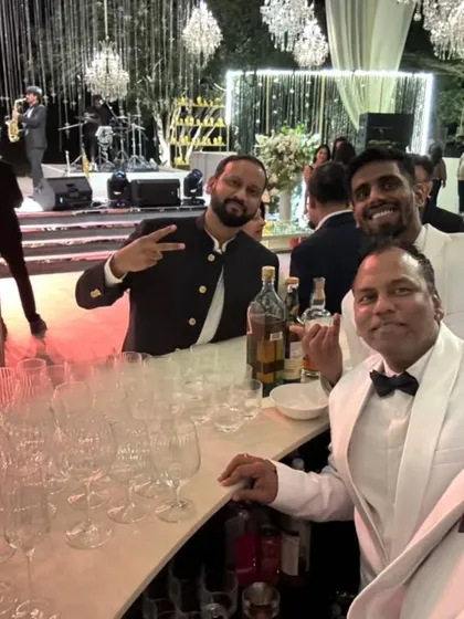 A great photo of our team with a happy guest at a wedding reception. Our goal is to make every guest's experience special.