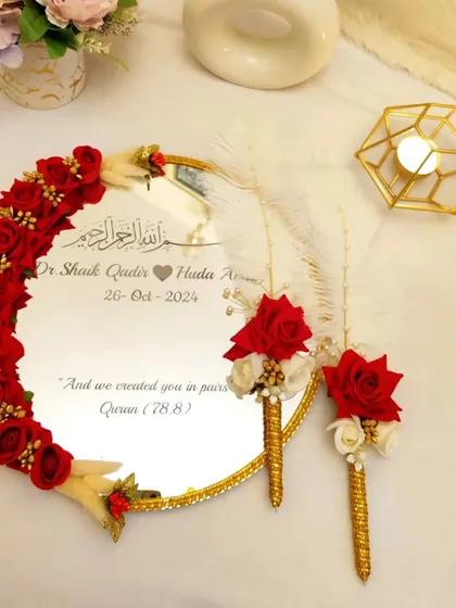 The 'Muah Dekhaye' is such a beautiful tradition. I designed this mirror with rich red roses and delicate feather pens to make that first look as a married couple truly unforgettable. The couple's names and wedding date are engraved to make it a keepsake for life.