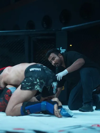 Checking on a fighter on the ground. Fighter safety is the number one priority for any good referee.