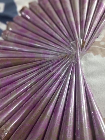 A fan of freshly made henna cones with beautiful purple wrappers. They are sealed and ready to be shipped out for you to enjoy.