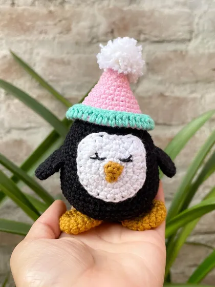 Meet Zippy the penguin. This little amigurumi character is made with soft cotton yarn and has a sweet, sleepy expression. I love how the little pom-pom party hat gives him such a fun personality.
