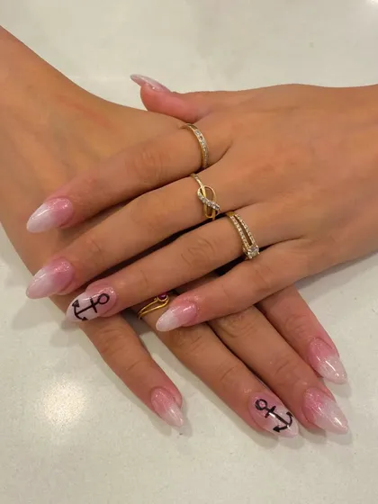 Perfect for a beach vacation or anyone who loves the sea. This nautical-themed manicure features a soft pink and white ombre base with a hand-painted black anchor accent nail.