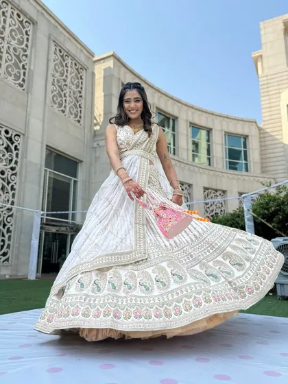 Radiating pure elegance for a day wedding event. I created a fresh, dewy makeup look with soft waves to complement her stunning white and gold lehenga.