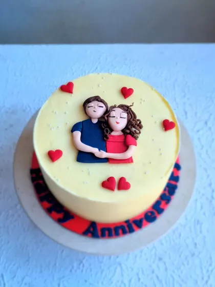 A top-down view of the anniversary cake, showing the placement of the fondant hearts.