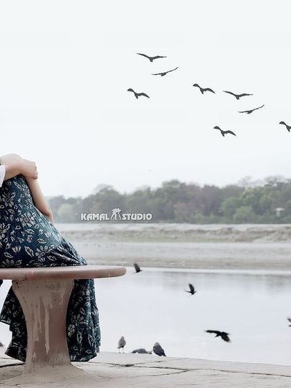 A quiet moment of reflection by the Yamuna river, with birds taking flight. This photo captures a sense of peace and togetherness, away from the crowds.
