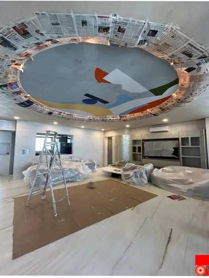 The 'Mumbai meri jaan' abstract ceiling mural during its creation, with the room protected and the initial color fields being applied. This shows the careful preparation required for on-site commissions.