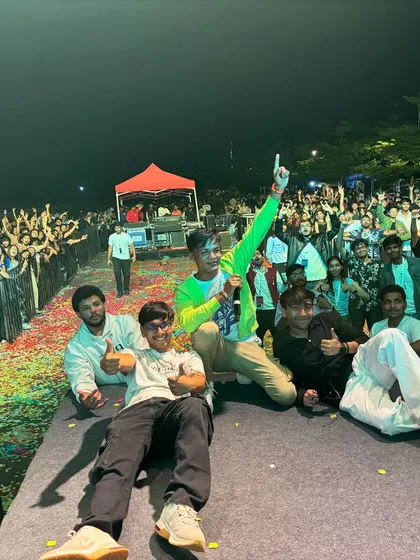 After a wild set, taking a moment with the crew on stage. You can see the massive, happy crowd and the confetti-covered floor behind us.