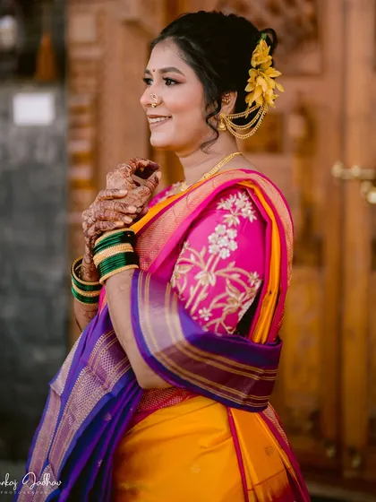 A beautiful portrait of the bride, Ankita, her smile as bright as her yellow and pink wedding saree.