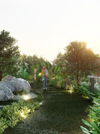 This pathway in the Sattva project's 'Sculpture Park' is illuminated by low-level lighting, highlighting the texture of the walkway and the surrounding boulders. The design creates a safe and atmospheric trail for evening strolls amidst nature and art.