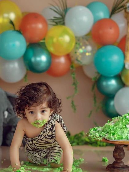 Getting ready to pounce on the cake. This shot captures the anticipation and excitement of a first birthday in our fun-filled jungle animal theme.
