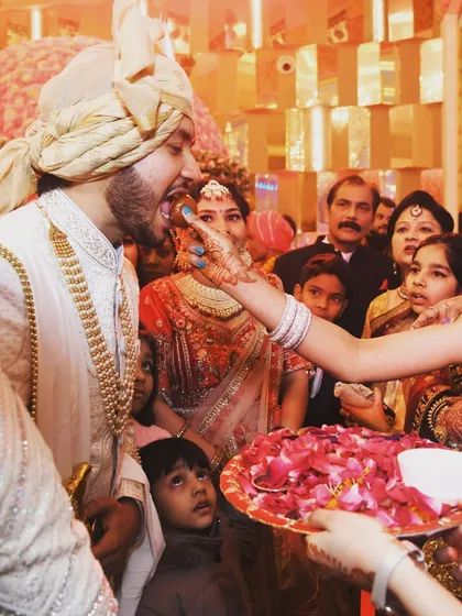 A sweet tradition where a family member feeds the groom. It's these small, personal rituals that make each wedding unique.