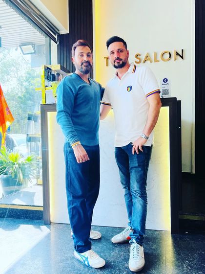 Posing with a happy client at the front of the salon. Building great relationships with my clients is part of the job.