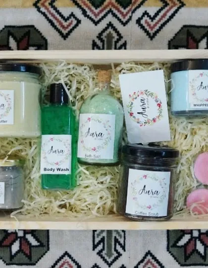 A beautiful trousseau hamper for the bride and groom. This wooden tray is filled with pamper essentials like Shea butter, body wash, bath salts, coffee scrub, and whipped soap.