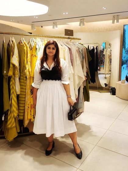 Another full-length view of the restyled black and white outfit, proving that styling is about creating a story worth wearing.