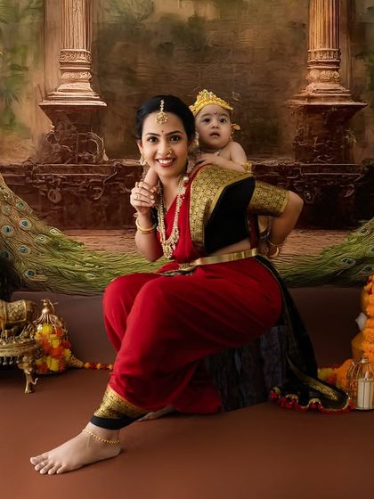 A duplicate of image 37, capturing a playful and unique pose with the baby peeking over his mother's shoulder against a peacock backdrop.