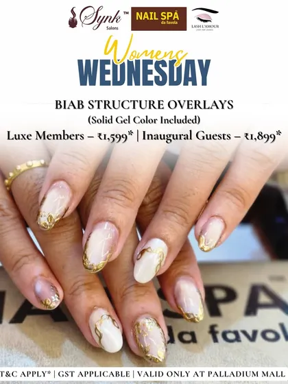 This image displays a gorgeous set of nails strengthened with BIAB structure overlays. The design features a marbled white and gold effect, offering a luxurious finish on a durable base.
