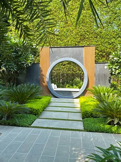 A unique circular seating nook nestled within a lush garden at a private residence in Kanpur. This feature acts as a tranquil focal point, demonstrating our passion for creating intimate, artistic spaces for quiet reflection and connection with nature.