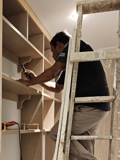 Another moment from the installation of the open shelving unit. The careful placement of each bracket and shelf ensures the final piece is not only beautiful but also strong and durable.