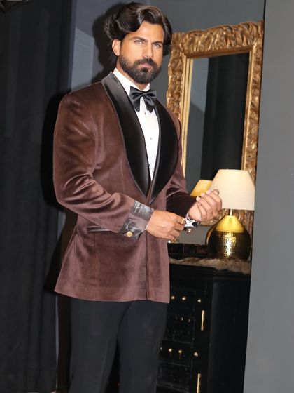 Our sophisticated brown velvet tuxedo with a contrasting black shawl lapel. This piece offers a warm and luxurious alternative to black, ideal for engagement parties and formal dinners.