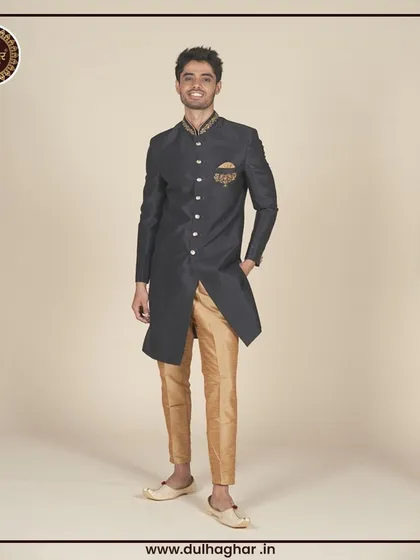 A black Indo-Western sherwani with gold trousers, offering a classic and opulent look.