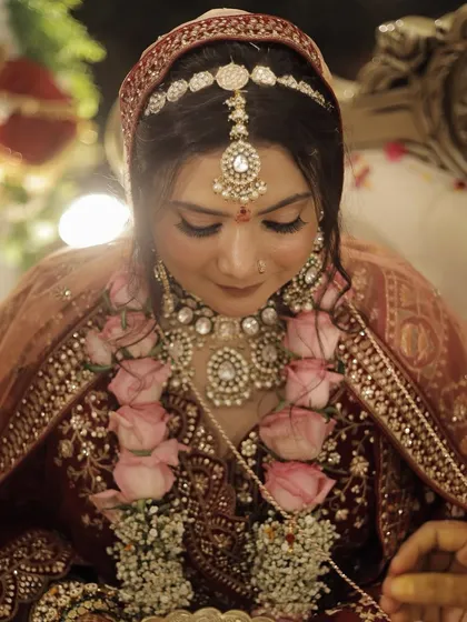 This candid shot during the jaimala ceremony shows the bride's glowing, natural-looking skin. I use techniques that ensure the makeup looks fresh and not heavy, even up close.