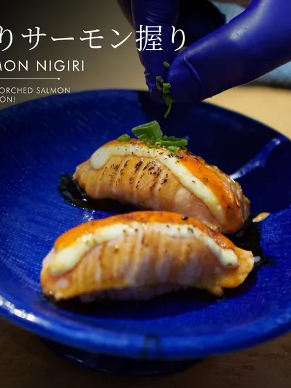Smoky torched salmon perfection. This branded image highlights our Salmon Nigiri as a signature dish, promising an exquisite taste of modern Japanese cuisine.