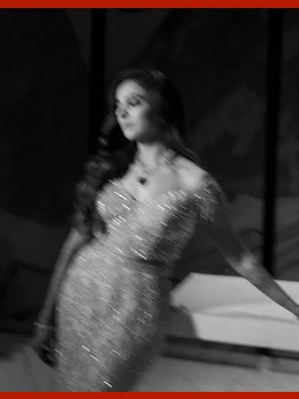 An artistic, motion-blur portrait of the bride. This black and white shot captures a sense of movement and dreaminess, focusing on the texture of her sparkling gown.