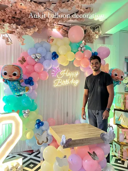 Here I am with the finished Cocomelon party setup, ready for the birthday celebration.