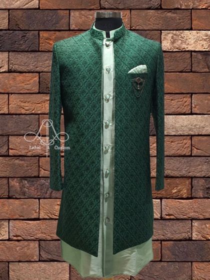 This deep green Indo-Western sherwani set is for the man who isn't afraid of color. The rich fabric and clean lines make it a powerful statement piece for any wedding event.