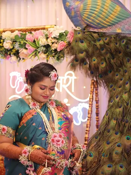 The happiness of the mom-to-be is the most important thing. This is a close-up from a peacock themed baby shower, showing the beautiful floral jewelry we provide.