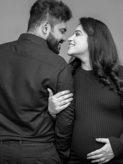 A beautiful black and white shot capturing the look of love between the expecting parents. These candid-style moments often make for the most cherished photographs.