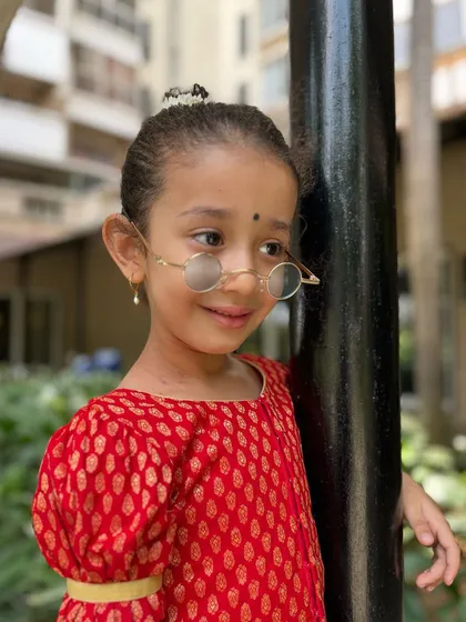 Leaning in with a gentle smile. This photo captures the sweet and expressive nature of our young students.