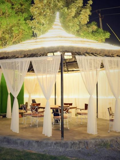 This spacious cabana is set up for a group dinner. The drapes can be drawn for more privacy, making it ideal for a special family meal or a get together with friends.