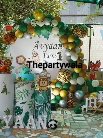 I can set up a party anywhere, even outdoors! This Jungle Safari theme looks amazing against the green background, with a custom backdrop, animal cutouts, and a big light-up "ONE" sign for a memorable first birthday.