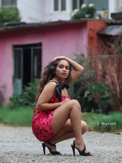 A crouching pose with a focus on the model's expression and the details of the dress.