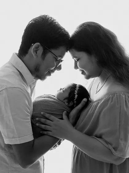 A beautiful high-key family portrait. The soft, bright light creates an angelic feel, perfectly capturing the purity and joy of this new beginning.