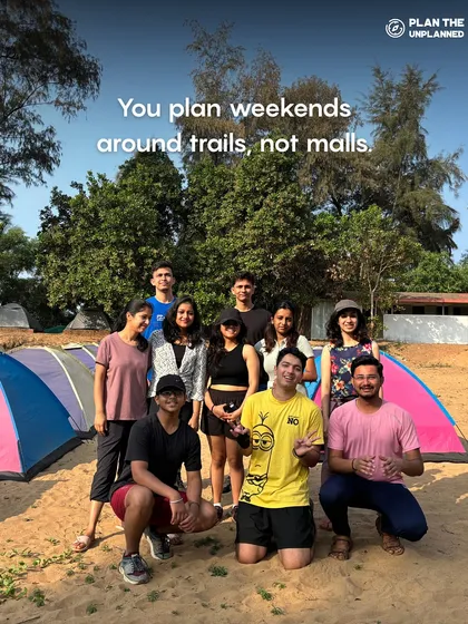 A group of friends camping on a beach. This image shows that you plan weekends around trails, not malls, which is the spirit of our community.