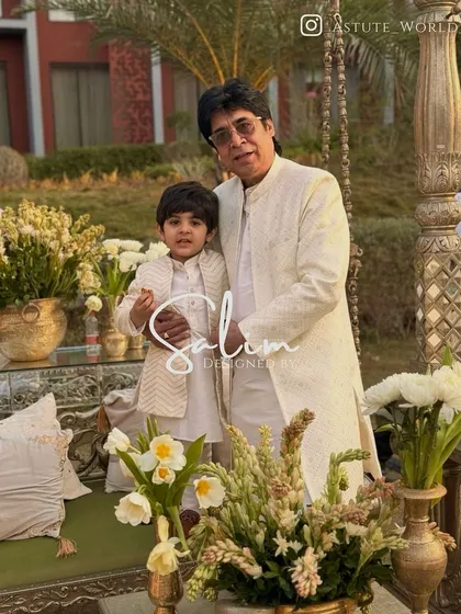 A heartwarming photo of a father and son in matching custom-designed ivory kurtas and jackets. I love creating coordinated outfits for family members to share on special occasions.