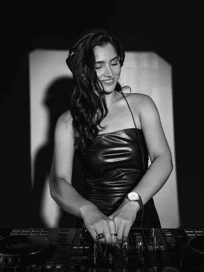 A smiling, black and white shot from the Armani Exchange photoshoot. It captures the joy I find in my work.