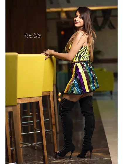 Confidence is key for a look like this. The makeup features a strong eye and contoured cheeks, designed to complement the thigh-high boots and sequined skirt for a cohesive, high-fashion statement. This is perfect for a birthday party or a special celebration.