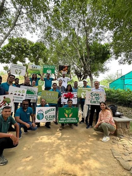 The Valvoline Cummins team poses with environmental signs at our Aranya nursery, celebrating a day of learning, connection, and purpose.