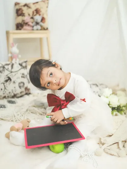 What a cutie! A simple, candid moment during a toddler session, where her personality just shines through.